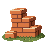 A large brick cut into three small bricks beside a chisel